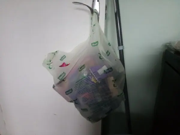 Better carrier bag hanging from door handle